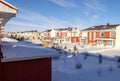 Raw of beautiful colorful houses in family village in winter time on blue clear sky background Royalty Free Stock Photo