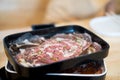 Raw beef being prepared on black tray