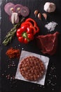 Raw beef Burger steak cutlets with ingredients. vertical top vie