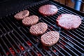 Raw beef burgers with a pinch of salt and black pepper on grill. prepared meat for grilling.Raw burger cutlets.tasty Royalty Free Stock Photo