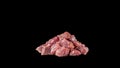 Raw beef, cubed and sprinkled with spices, on a slate and black background