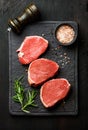Raw beef Eye Round steaks with spices and rosemary Royalty Free Stock Photo