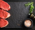 Raw beef Eye Round steaks with spices, rosemary. Copy space Royalty Free Stock Photo