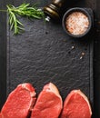 Raw beef Eye Round steaks with spices, rosemary. Copy space Royalty Free Stock Photo