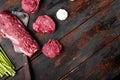 Raw beef filet Mignon steak cut , with old butcher cleaver knife, on old dark wooden table background, top view flat lay, with