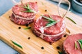 Raw beef filet mignon steak on a wooden board with rosemary and spices Royalty Free Stock Photo