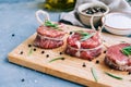 Raw beef filet mignon steak on a wooden board with rosemary and spices Royalty Free Stock Photo