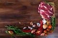 Raw beef with fresh vegetables on wooden background Royalty Free Stock Photo