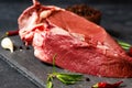 Raw beef heart meat on stone board with thyme and peppers Royalty Free Stock Photo