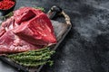 Raw beef liver offal on a cutting board. Black background. Top view. Copy space Royalty Free Stock Photo