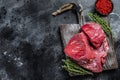 Raw beef liver offal on a cutting board. Black background. Top view. Copy space Royalty Free Stock Photo