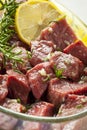 Raw Beef Marinating with Lemon, Oil and Herbs