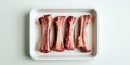 Raw beef marrow bones arranged in white tray on light background for broth or roasting Royalty Free Stock Photo
