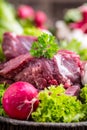 Raw beef meat with fresh vegetable. Sliced beef steak in lettuce salads radishes and mushrooms Royalty Free Stock Photo