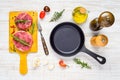 Raw Beef Meat with Frying Pan and Cooking Ingredients Royalty Free Stock Photo