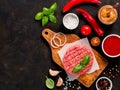 Raw beef meat steak cutlet for burger with spices and vegetables Royalty Free Stock Photo