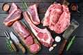 Raw beef meat steaks, tomahawk, t bone, club steak, rib eye and tenderloin cuts, on black wooden background, top view flat lay Royalty Free Stock Photo