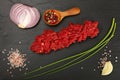 Raw beef minced meat and spices on black board Royalty Free Stock Photo