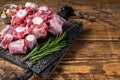 Raw beef Oxtail cut Meat on wooden cutting board with knife. wooden background. Top view. Copy space