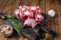 Raw beef Oxtail cut Meat on wooden cutting board with knife. wooden background. Top view