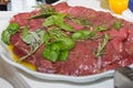 Raw Beef ready to be Cooked and Prepared with Oil, Pepper, Basil, Rosemary and Bay Leaves Royalty Free Stock Photo