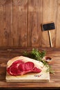 Raw beef Rib bone steak on wooden board and table Royalty Free Stock Photo