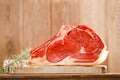 Raw beef Rib steak with bone on wooden board Royalty Free Stock Photo