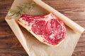 Raw beef Rib steak with bone on wooden board and table Royalty Free Stock Photo