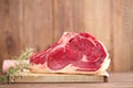 Raw beef Rib steak with bone on wooden board and table Royalty Free Stock Photo