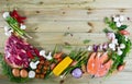 Raw beef, salmon and vegetables on wooden background Royalty Free Stock Photo