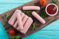 Raw beef sausages with pepper , herbs and ketchup Royalty Free Stock Photo