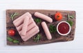 Raw beef sausages with pepper , herbs and ketchup Royalty Free Stock Photo