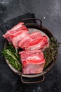 Raw Beef Short Rib, uncooked meat with bone and fat. black background. top view Royalty Free Stock Photo
