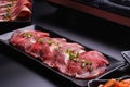 Raw beef slice for barbecue japanese style, yakiniku, meat are being cooked on stove Royalty Free Stock Photo