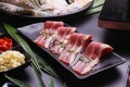 Raw beef slice for barbecue japanese style, yakiniku, meat are being cooked on stove Royalty Free Stock Photo