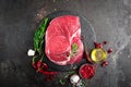 Raw beef steak on black background with cooking ingredients. Fresh beef meat Royalty Free Stock Photo