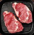 Raw beef steak on cooking pan Royalty Free Stock Photo