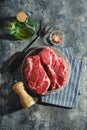 Raw beef steak on dark gray background Royalty Free Stock Photo