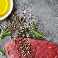 Raw Beef Steak with Peppercorns Sea Salt Olive Oil and Rosemary
