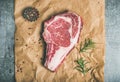 Raw beef steak rib-eye with seasoning on craft paper Royalty Free Stock Photo