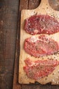 Raw beef steak and spicel on cutting board on the table Royalty Free Stock Photo