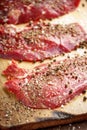 Raw beef steak and spicel on cutting board on the table Royalty Free Stock Photo