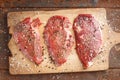 Raw beef steak and spicel on cutting board Royalty Free Stock Photo