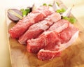 Raw beef steaks. Arrangement on a cutting board.