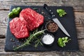 Raw beef steaks on a black slate tray Royalty Free Stock Photo