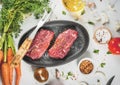 Raw beef steaks with vegetables Royalty Free Stock Photo