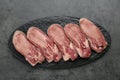 Raw beef tongue pieces on grey table, top view Royalty Free Stock Photo