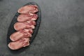 Raw beef tongue pieces on grey table, top view and space for text Royalty Free Stock Photo