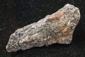 raw biotite nepheline syenite stone on dark Royalty Free Stock Photo