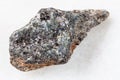 raw biotite nepheline syenite stone on white